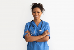 a nurse posing with crossed arms and smiling