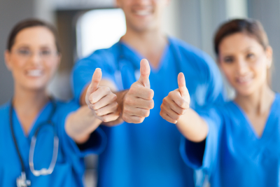 group of healthcare workers thumbs up